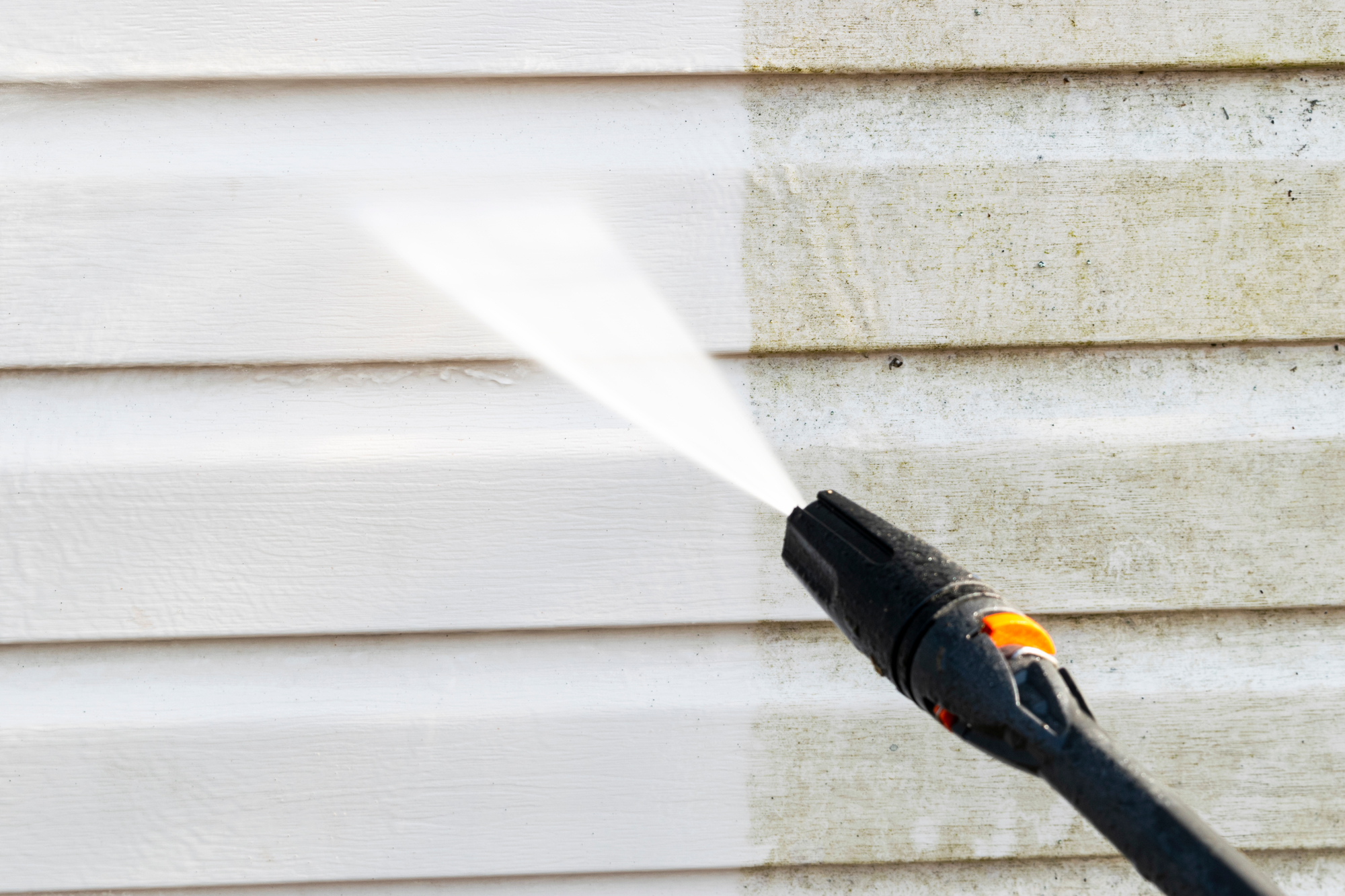 Cleaning Dirty Wall With High-Pressure Water Jet