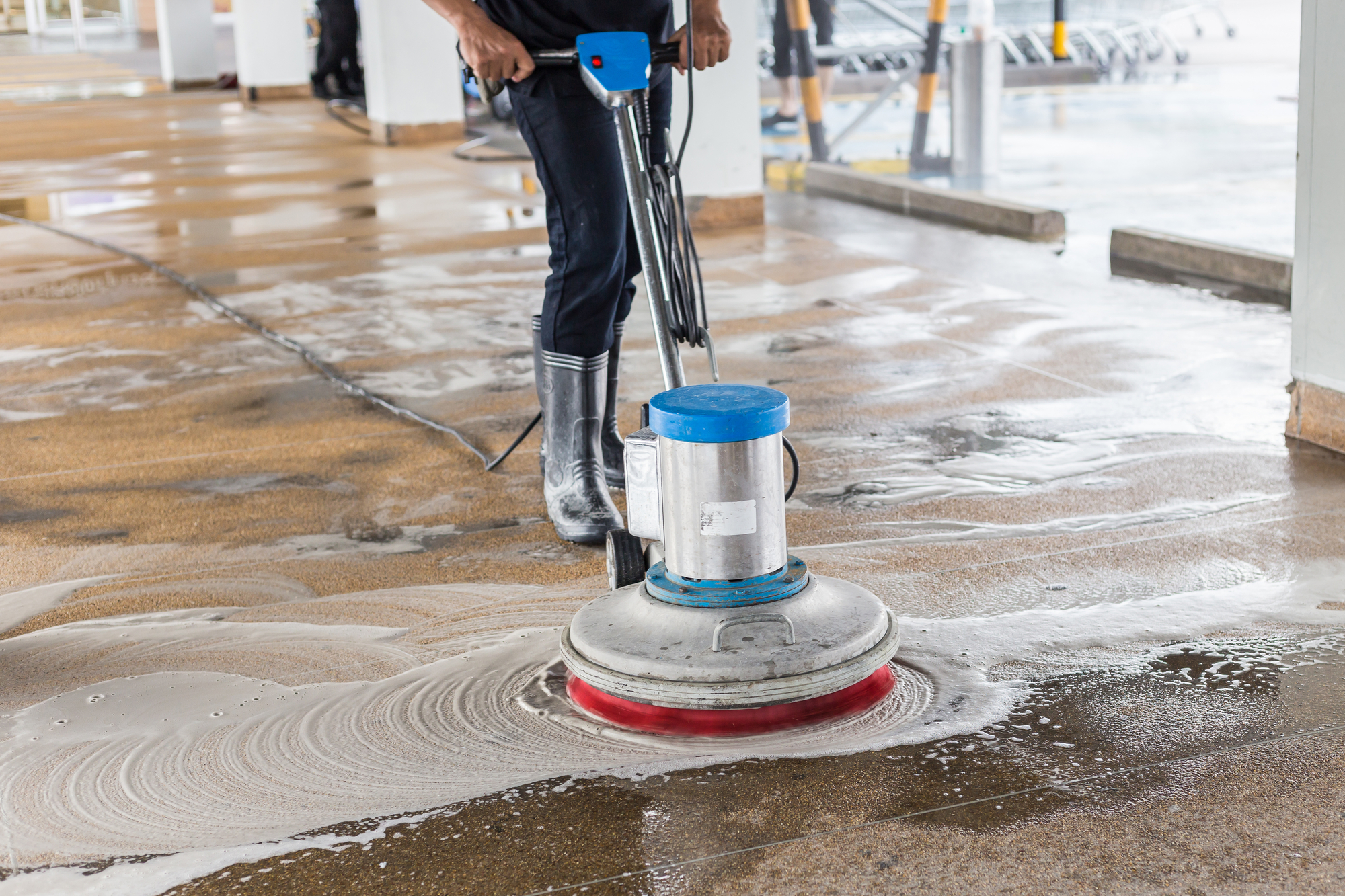 Worker Cleaning Sand Wash Exterior Walkway